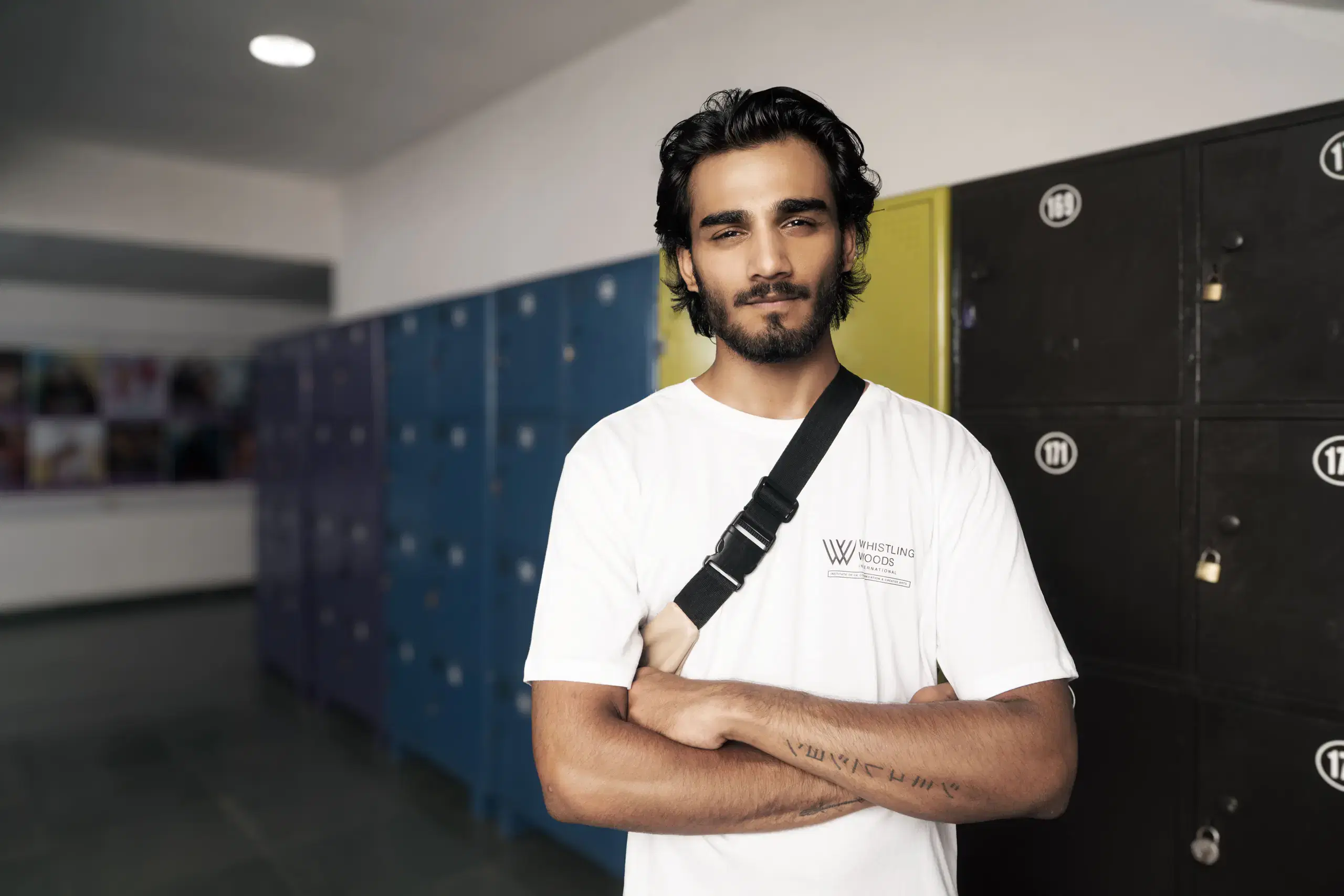 Whistling Woods student standing by the campus lockers