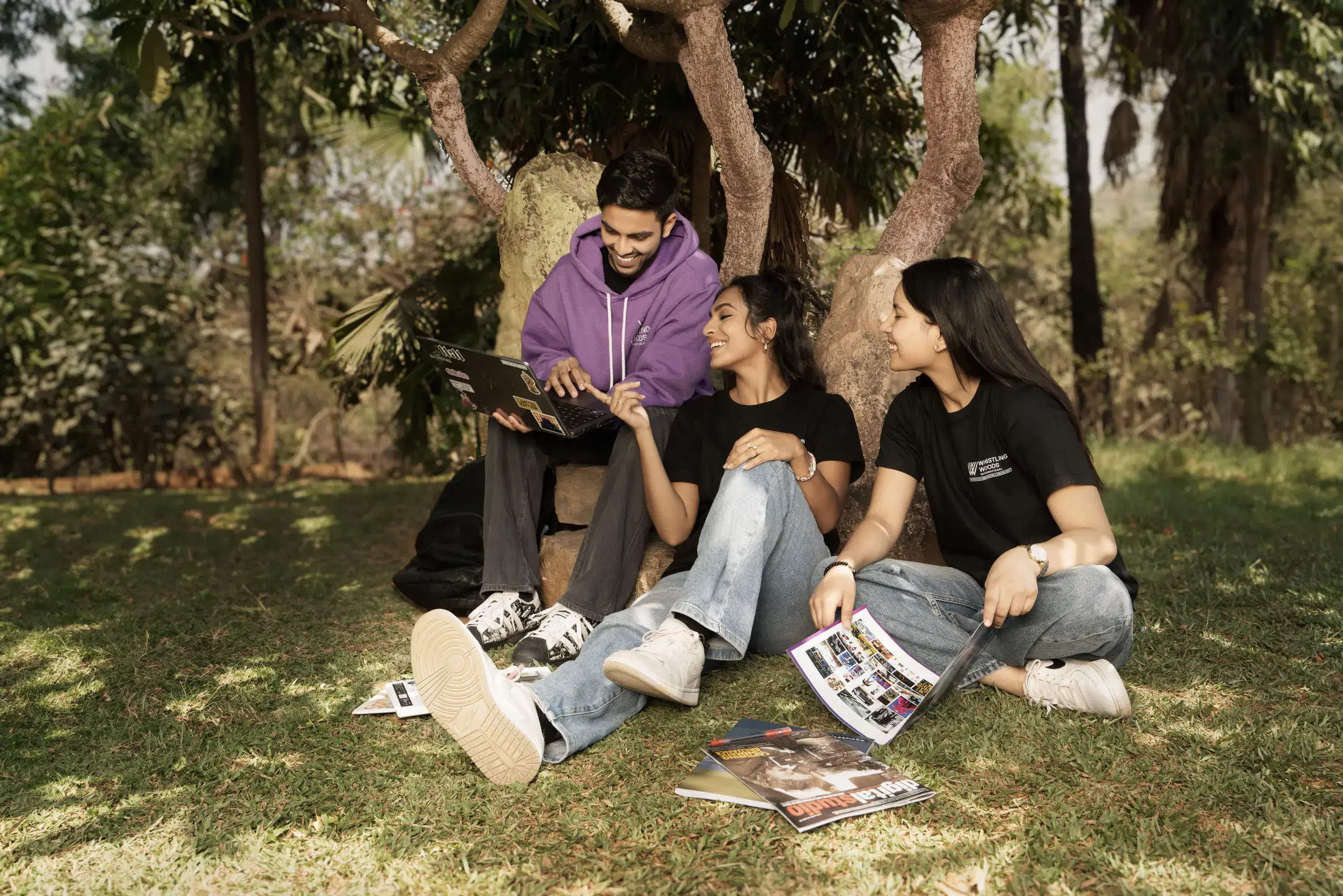 Whistling Woods students studying together on the campus lawn