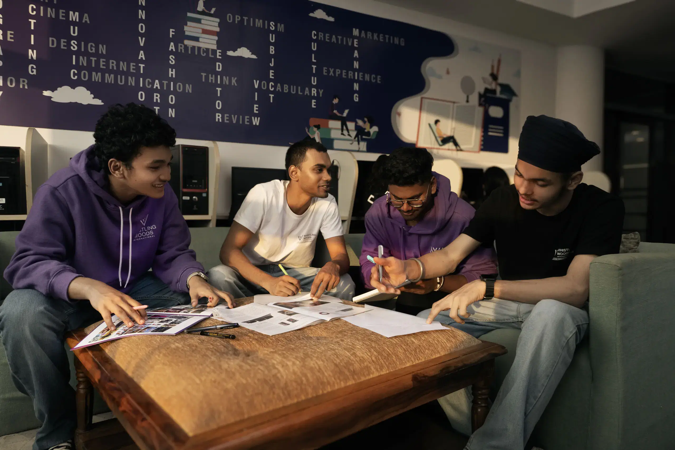 Whistling Woods students working on sketches together in a common room