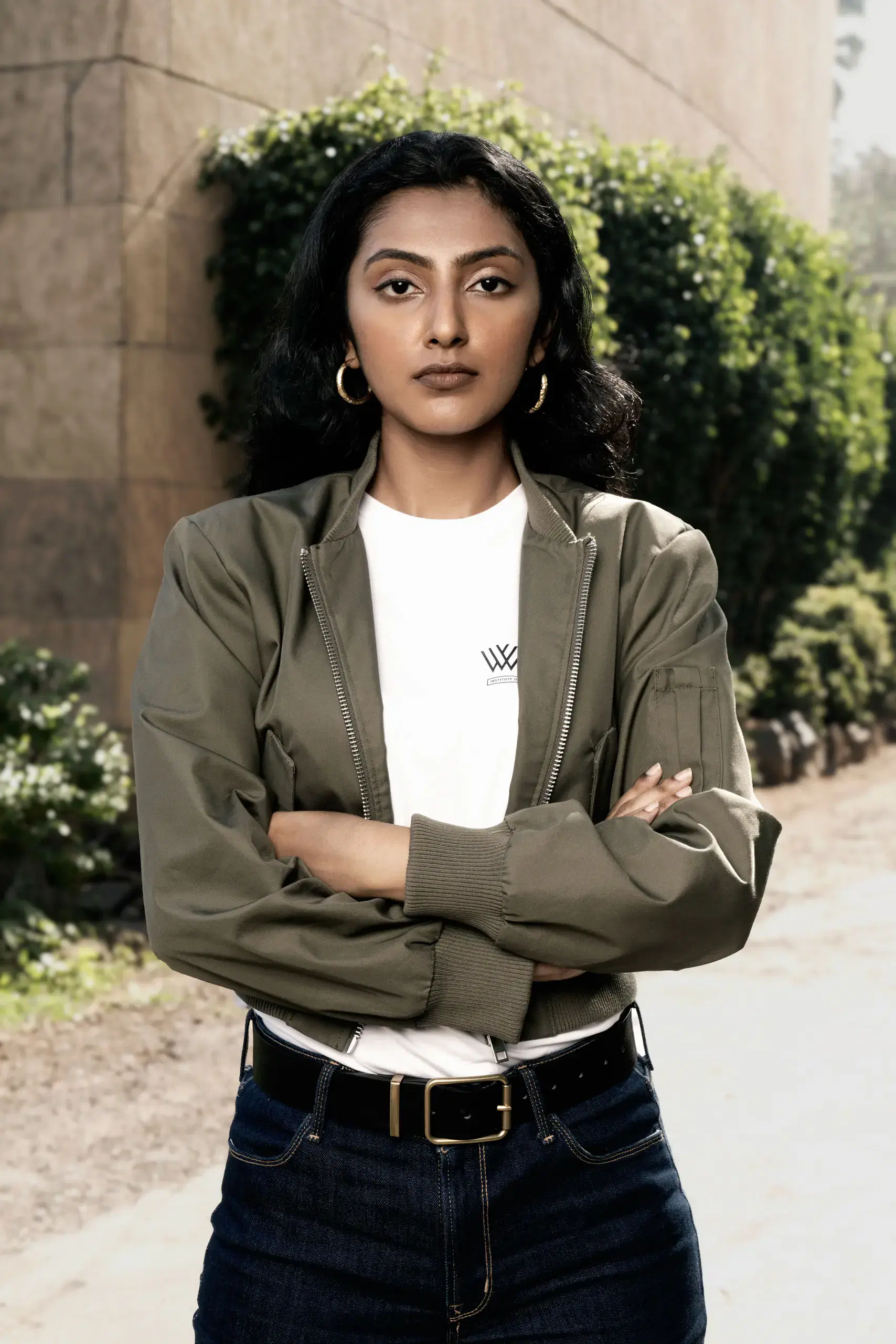 Whistling Woods student in a college T-shirt and jacket, standing outdoors