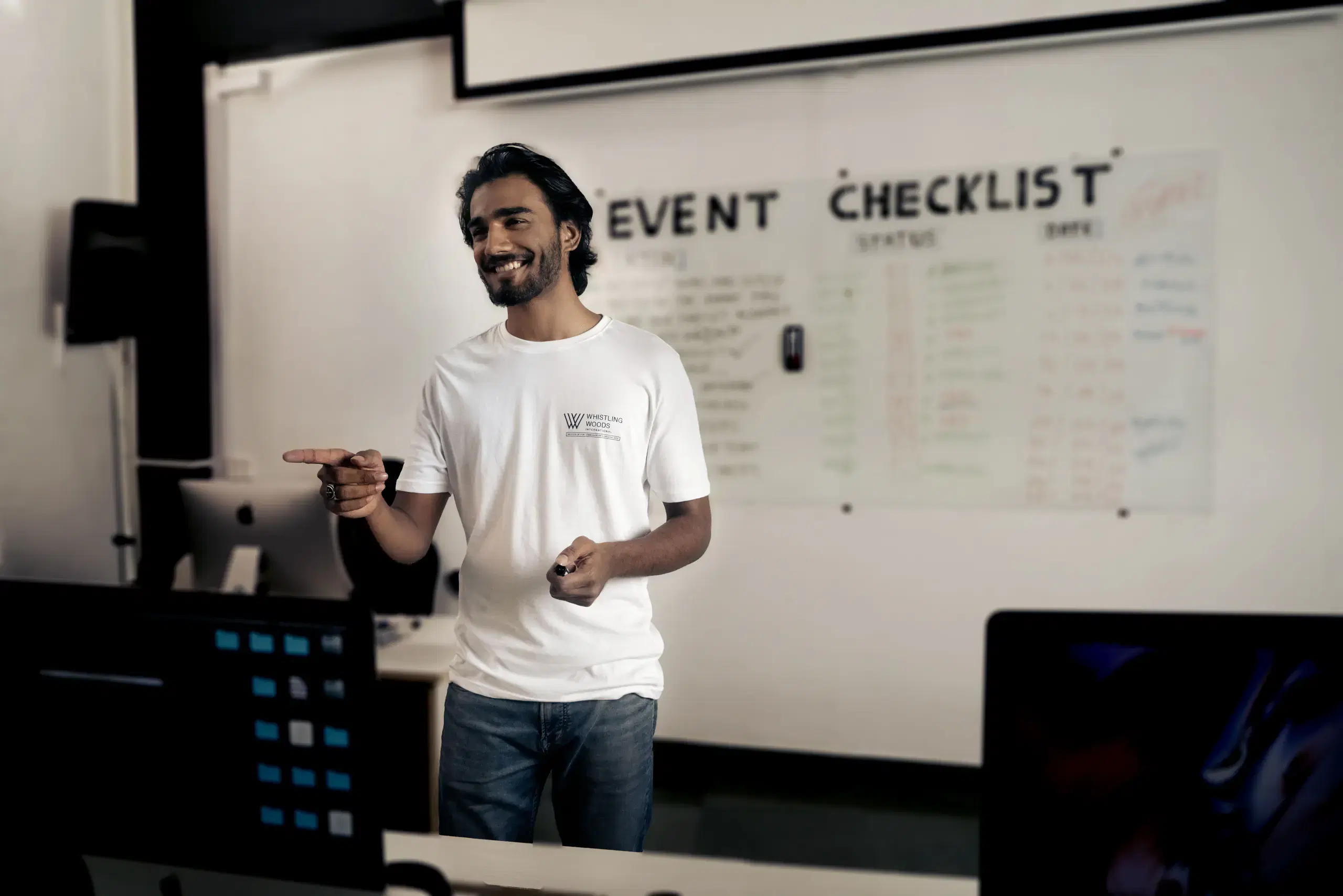 Student presenting at a whiteboard in a classroom
